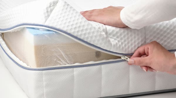 a foam mattress cover being unzipped