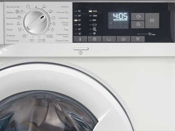 A focus picture of the buttons of a TVÄTTAD integrated washing machine.
