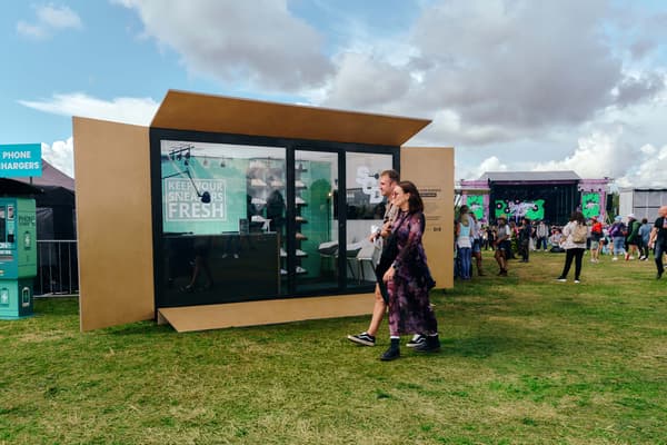 A front view of a pop-up shop in a field 