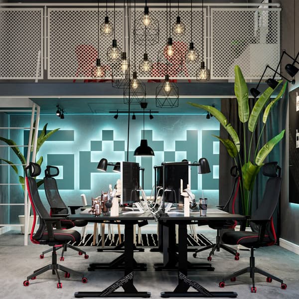 A futuristic room with a mezzanine balcony overlooking a collective workspace formed by UPPSPEL desks and MATCHSPEL chairs.