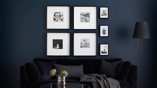 A gallery wall with framed black and white photos.