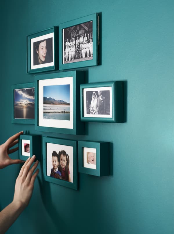 A gallery wall with painted photo frames.