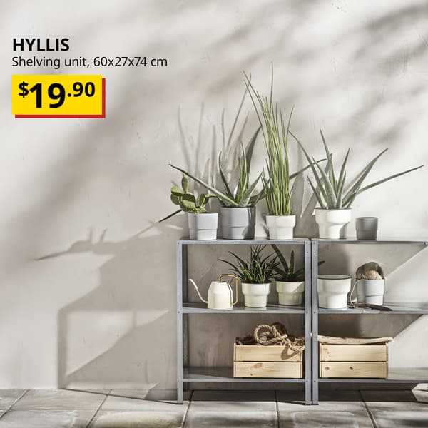 A galvanised HYLLIS steel shelving unit for both in/outdoor placed at the service yard with live plants on the top and gardening tools on the lower shelving. Text on the top left of the image reads: HYLLIS, Shelving unit, 60x27x74 cm. Price: $19.90. 