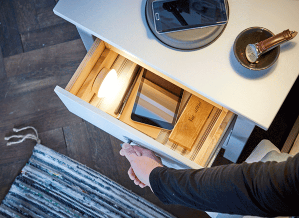 A GIF of a bedside table drawer being opened to reveal a MOLGAN LED light inside.