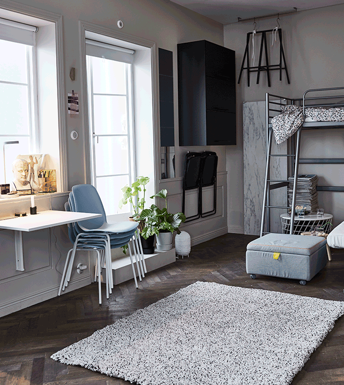 A GIF of a dining area being created with a rug, table base, table top and chairs.