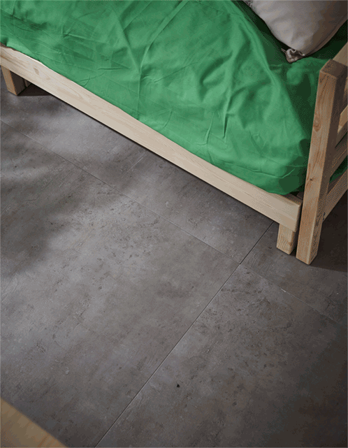  A GIF of a rolling storage box coming out from under the bed in a dorm room.