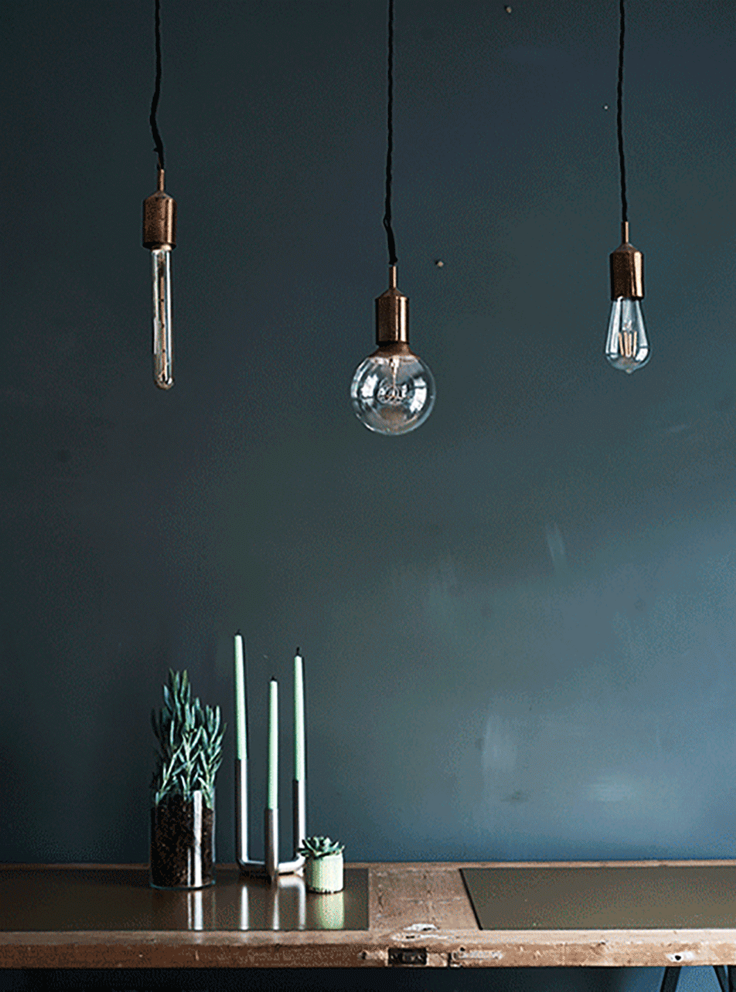 A gif showing bulbs hung over a dining table.