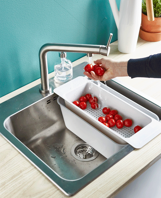 A GIF shows tomatoes being rine in the sink, while the water is saved in a tub and used to water plants.