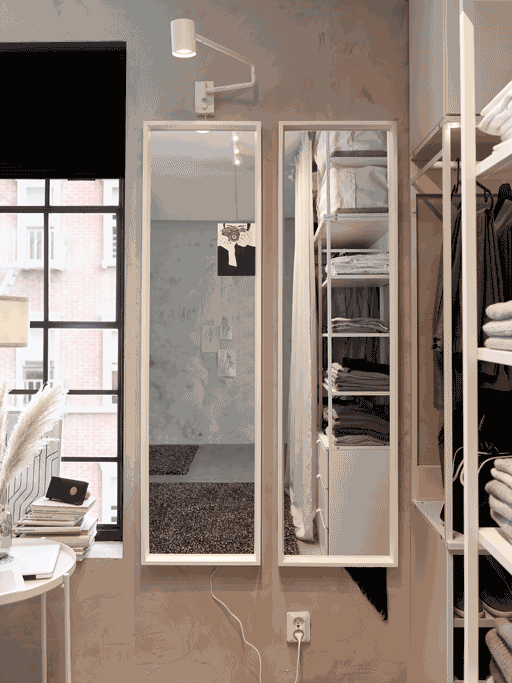 A GIF with two NISSEDAL mirrors that hang on a wall. One is hanging on its side hinges and turns back and forth.
