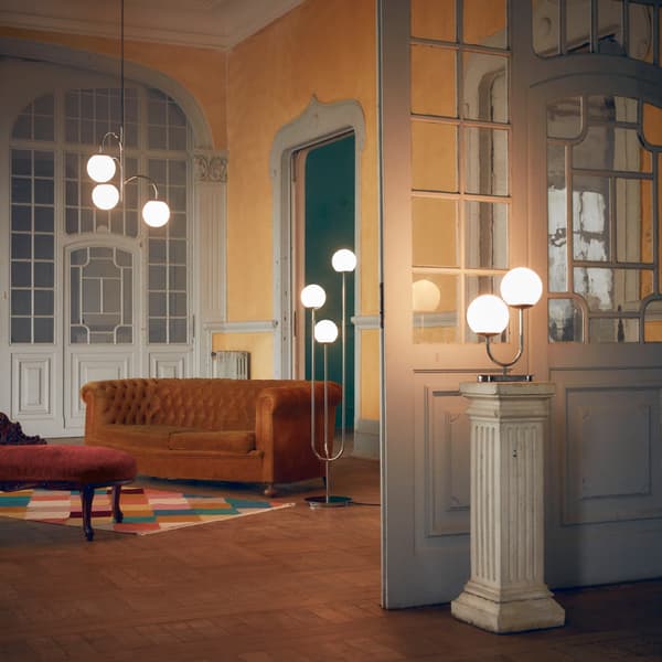 A grand room showing three SIMRISHAMN lamps — a pendant, floor and table lamp with their glass domes lit up.