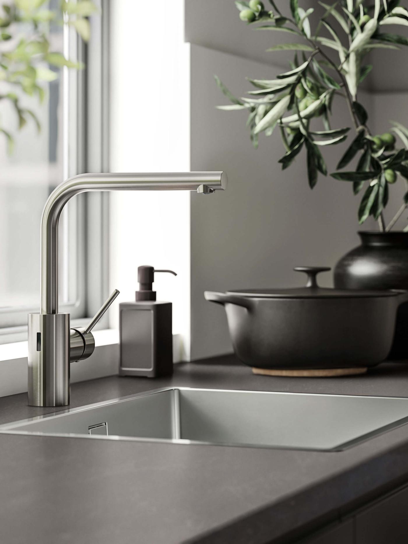 A gray countertop with an inset sink and a stainless steel faucet.