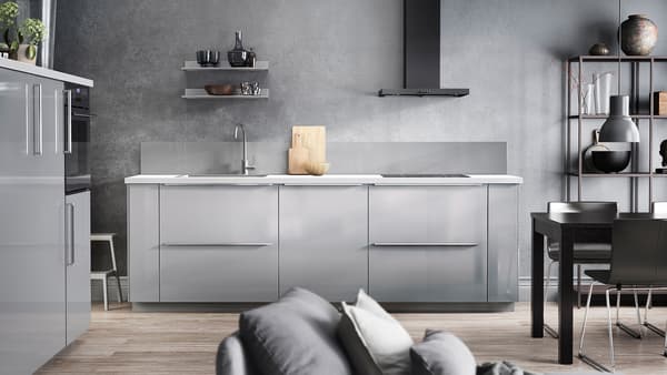 A gray kitchen with high-gloss RINGHULT drawer fronts and doors in light gray, a white worktop and a black extractor fan.