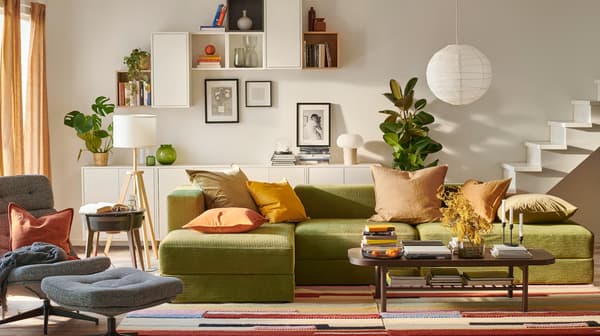 A green JÄTTEBO sofa in the living room with bright colours.