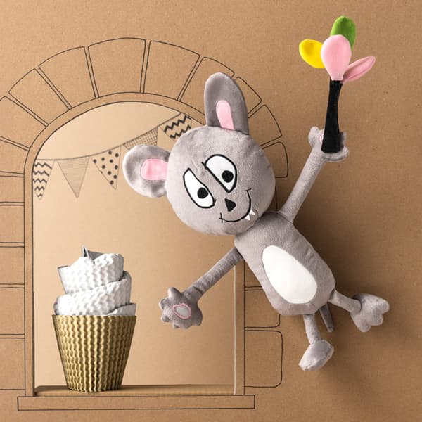 A grey and white IKEA SAGOSKATT soft toy – a party mouse with balloons flying in front of a cardboard castle.