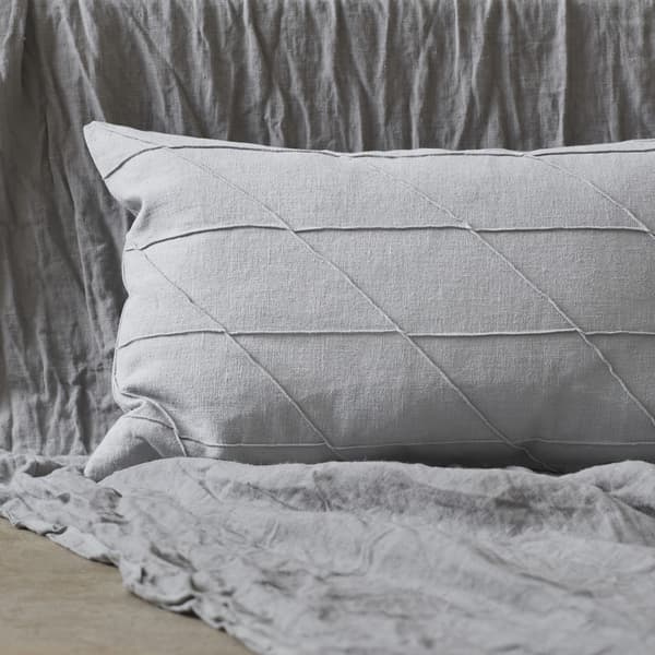 A grey cushion with textured stitching.