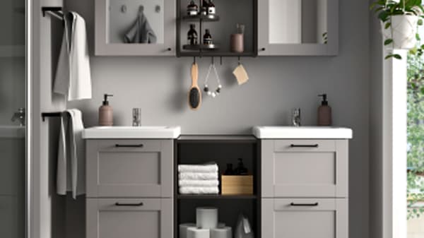 A Grey ENHET laundry combination on the gloomy laundry room.