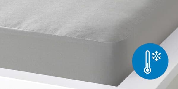 A grey mattress with a symbol enclosed by a blue circle. The symbol is a thermometer with a snowflake