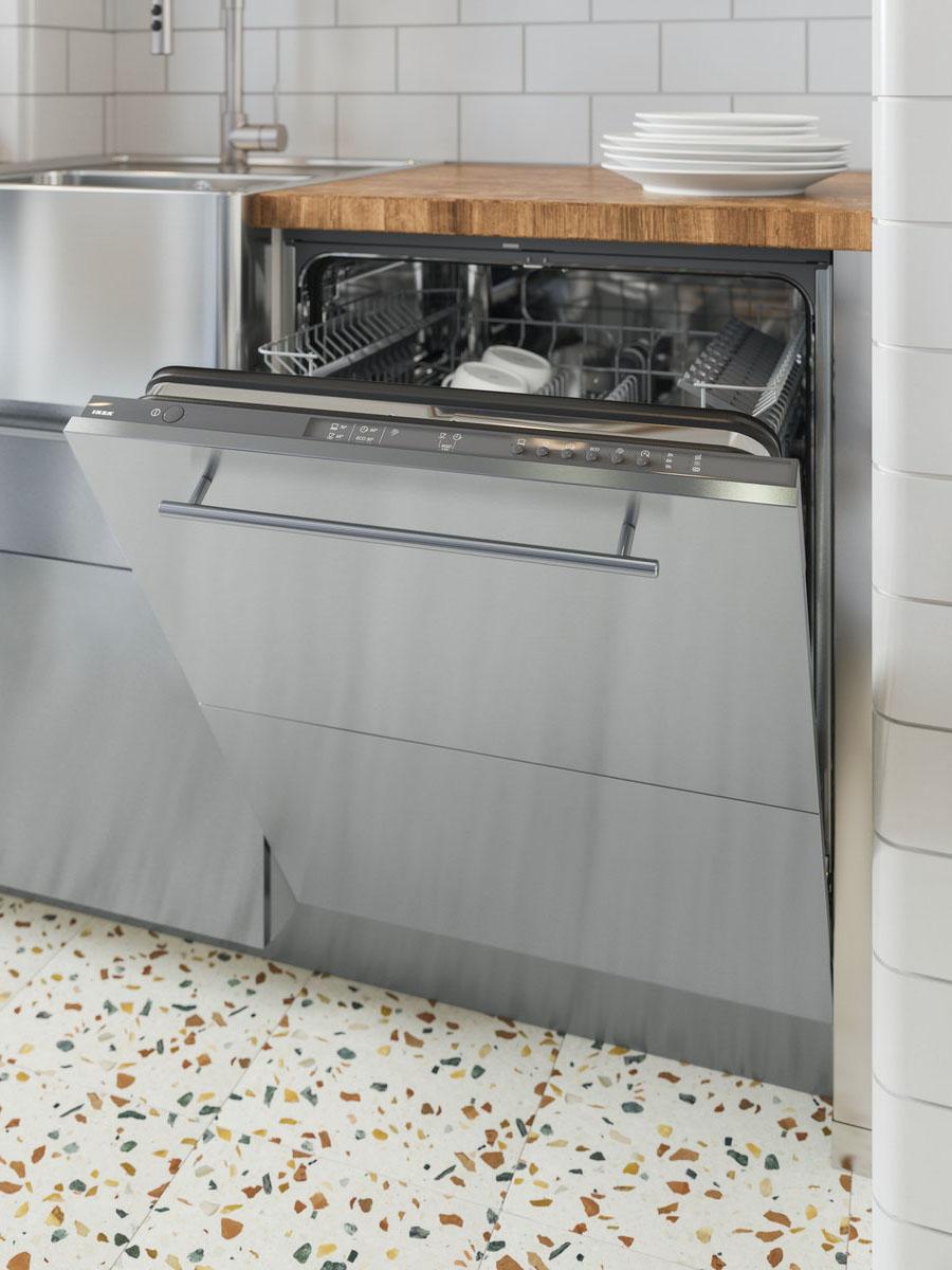 A grey RENGÖRA integrated dishwasher in the kitchen half open