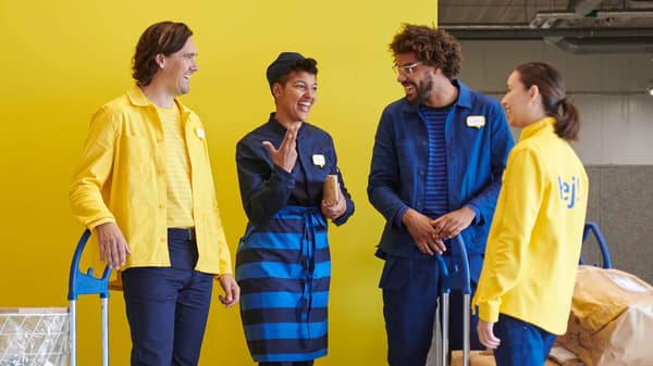 A group of IKEA co-worker wearing a yellow IKEA uniform.