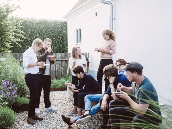 A group of people enjoying dessert outdoors as part of a food club in Sweden.