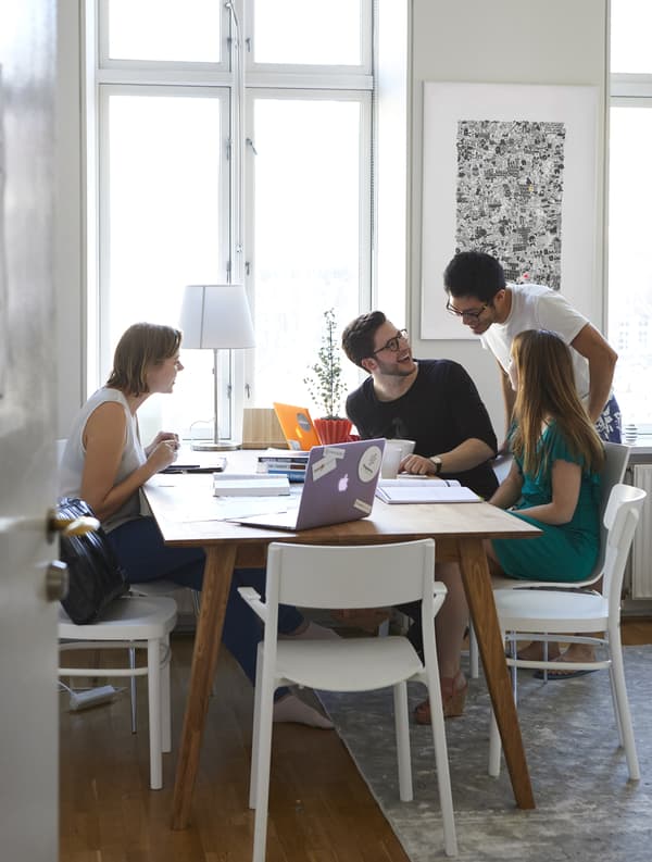 A group of people working together at a table.
