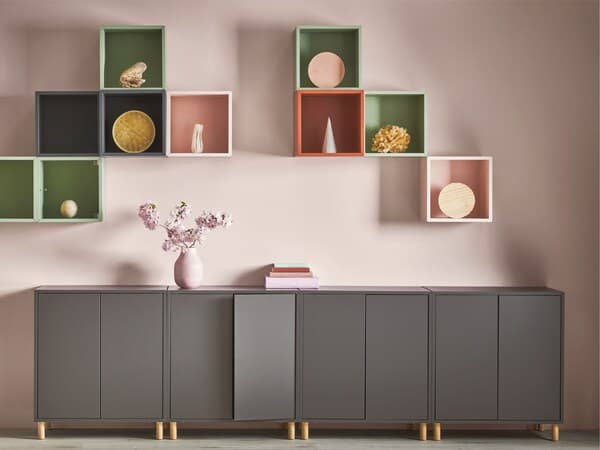 A half-height grey EKET chest of drawers and EKET wall shelves.