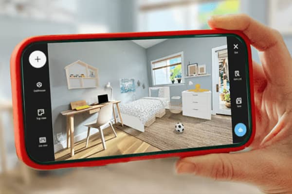 A hand holds a mobile phone that is scanning a bedroom.