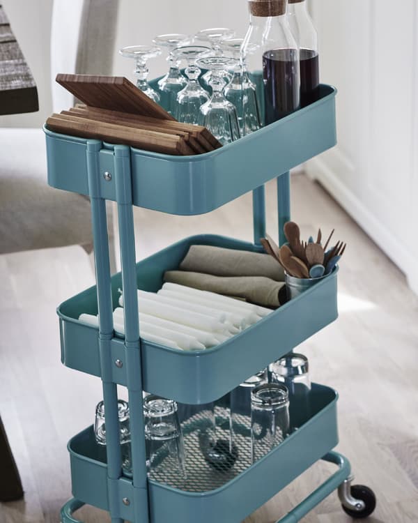 A handy trolley is an easy way to deliver cutlery, glassware and plates to the table.
