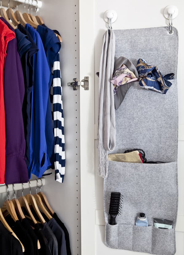 A hanging organiser and clothes on a rail.