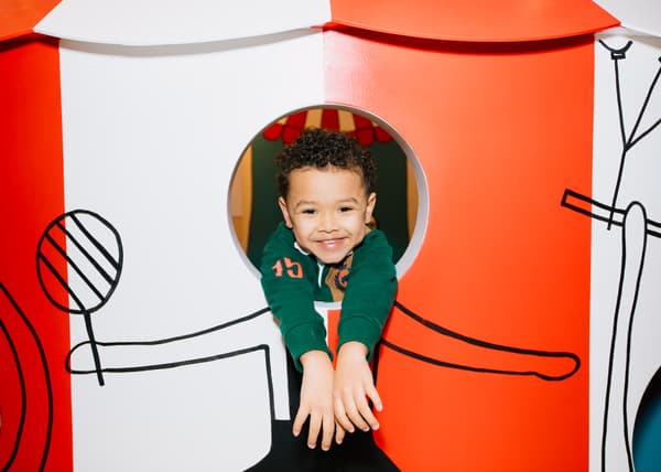 A happy faced child in a tent 
