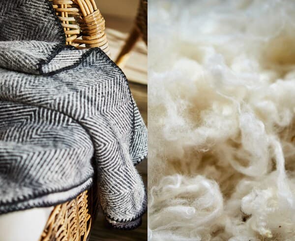 A herringboned patterned wool throw on a wicker chair beside