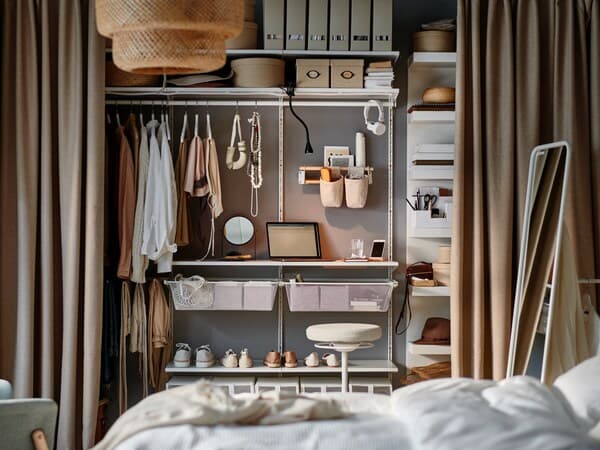 A high open BOAXEL wardrobe can be seen in front of a bed.