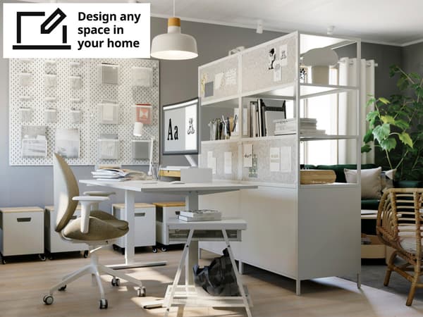 A home office area located next to a living room setting. Showcasing a Gunnared beige HATTEFJÄLL office chair with armrests, a white MITTZON sit/stand desk, white TROTTEN cabinets and a wall of white SKÅDIS pegboard wall organiser. 