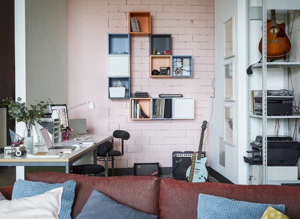 A home office with pink wall.