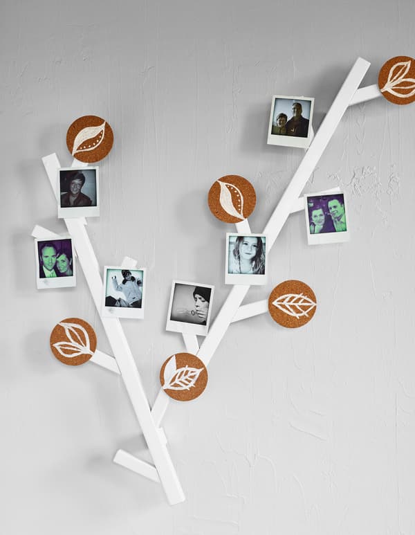 A homemade family tree hangs on a white wall.