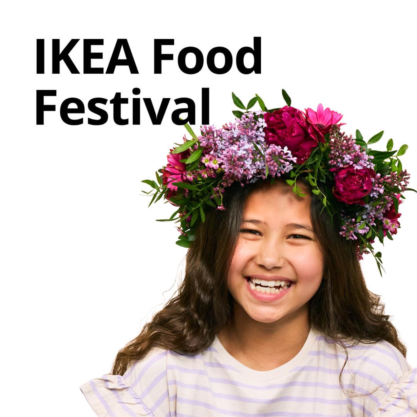 A joyful young girl with long dark hair smiles brightly, adorned with a vibrant floral crown of pink and purple blossoms, celebrating the IKEA Food Festival.