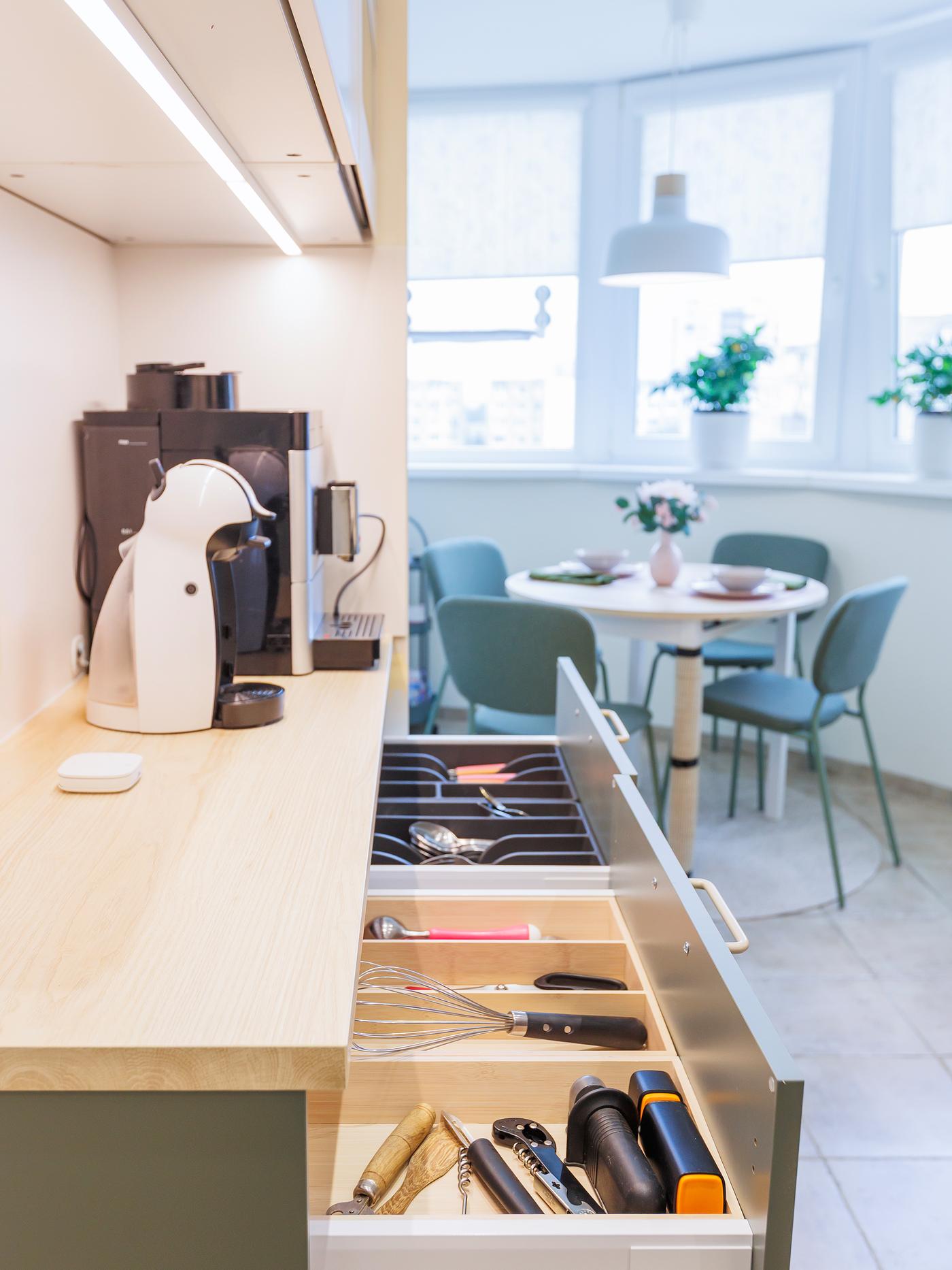 A kitchen drawer with neatly organised drawer inserts and trays, providing efficient storage for kitchen utensils and tools.