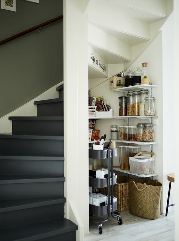 A kitchen pantry under the stairs.