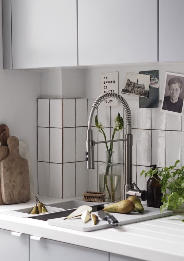 A kitchen sink and mixer tap with handspray. 