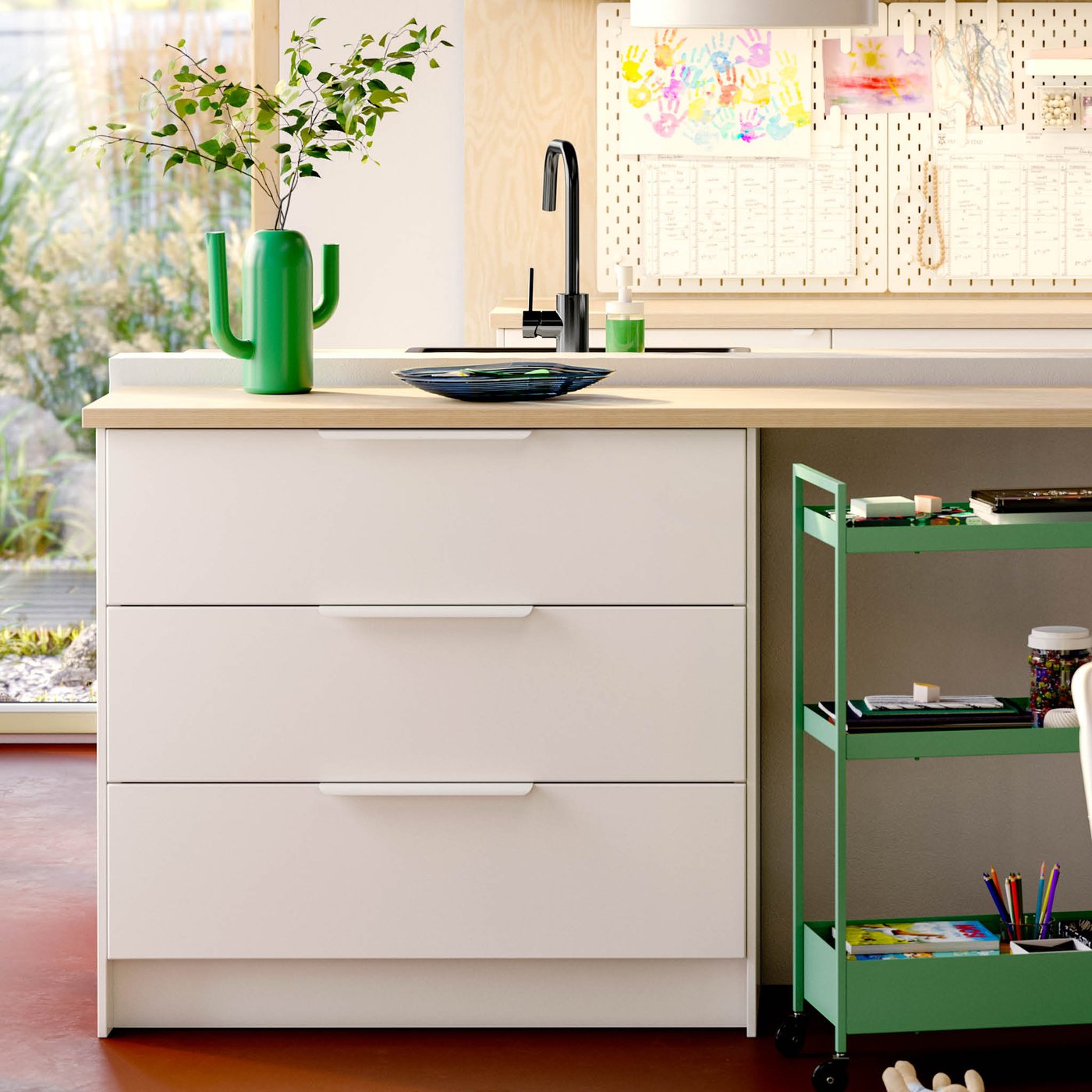 A kitchen sink and tap, in a white airy bright kitchen.
