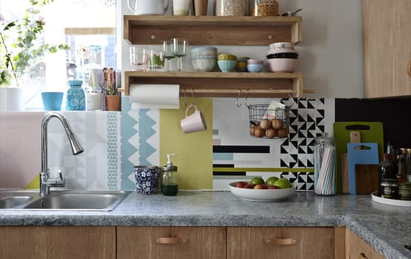 A kitchen with a colourful splashback