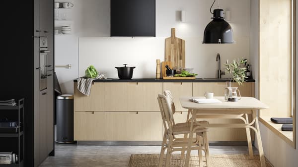 A kitchen with a small dining table.