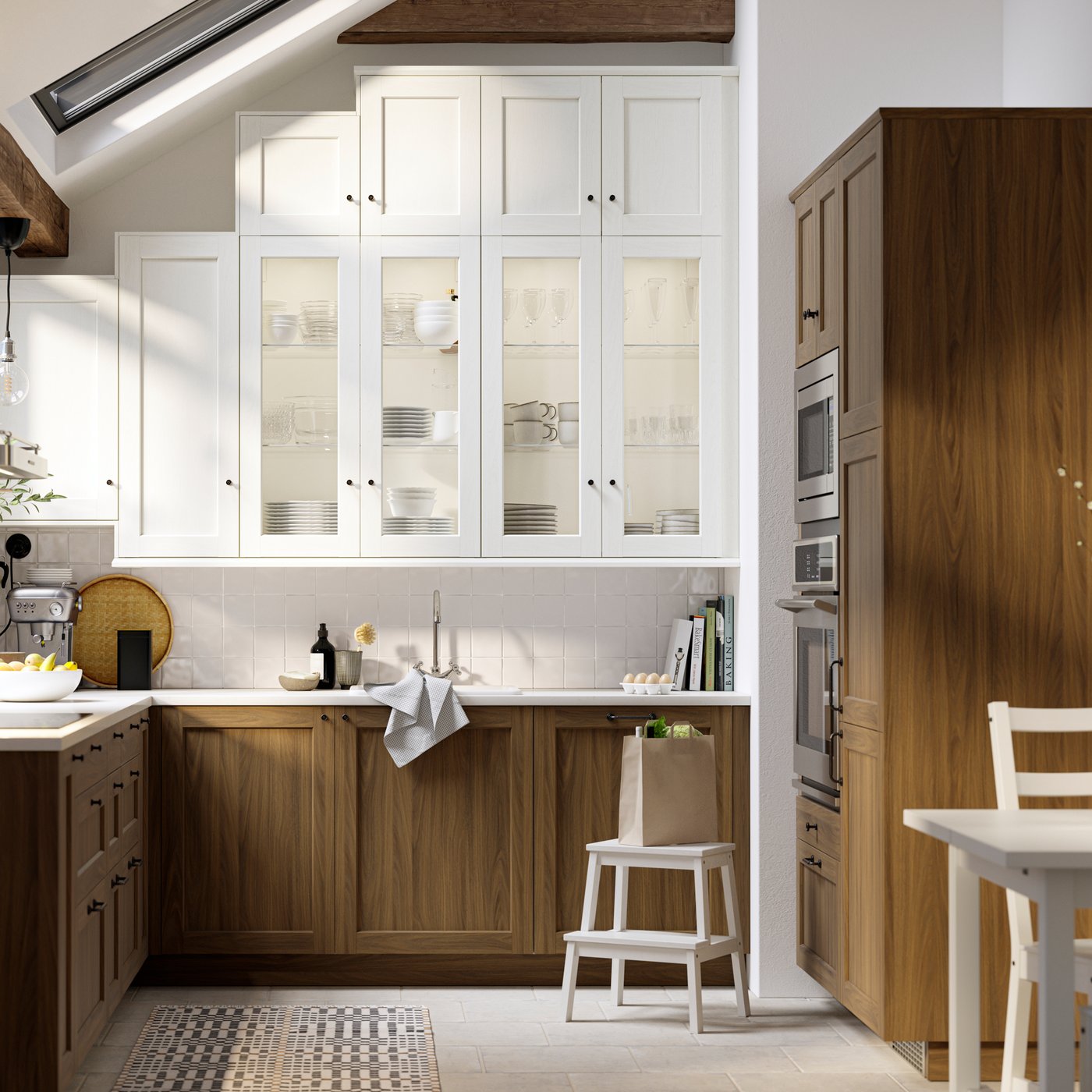 A kitchen with white wood effect ENKÖPING doors and glass doors, plus brown walnut effect ENKÖPING doors and drawer fronts.