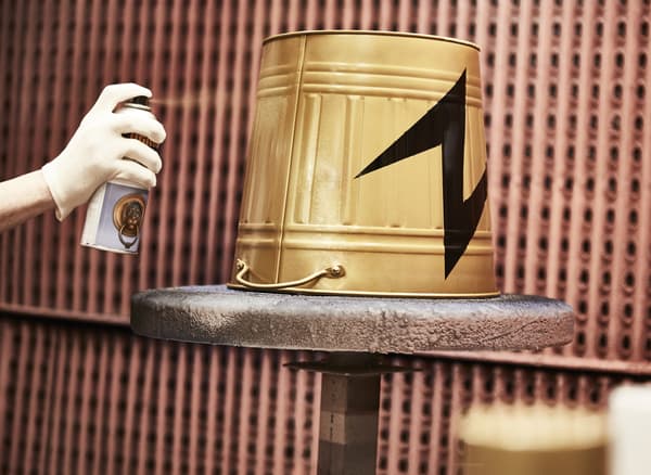 A KNODD bin is flipped upside down and spray painted gold with a black lightening bolt.