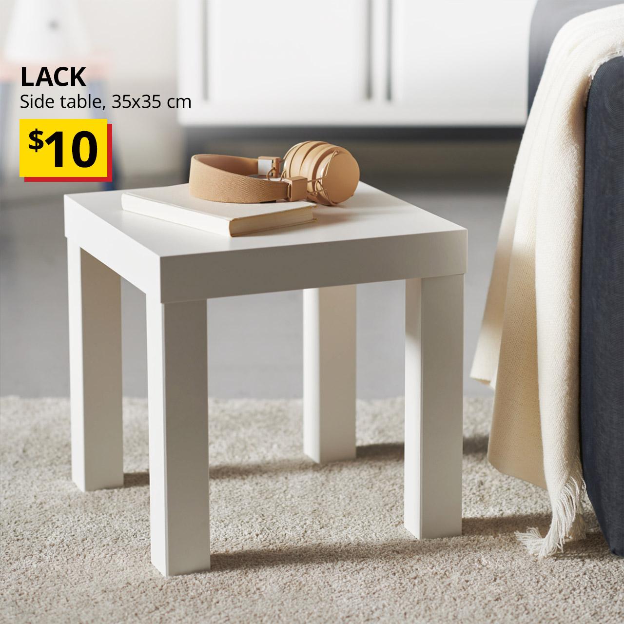 A LACK side table in white with a pastel pink headphone and noteboook being placed on top. Words on image reads "LACK, side table, $10" 