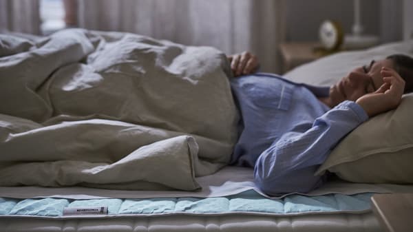 a lady sleeps soundly on a comfortable bed with a cooling pad