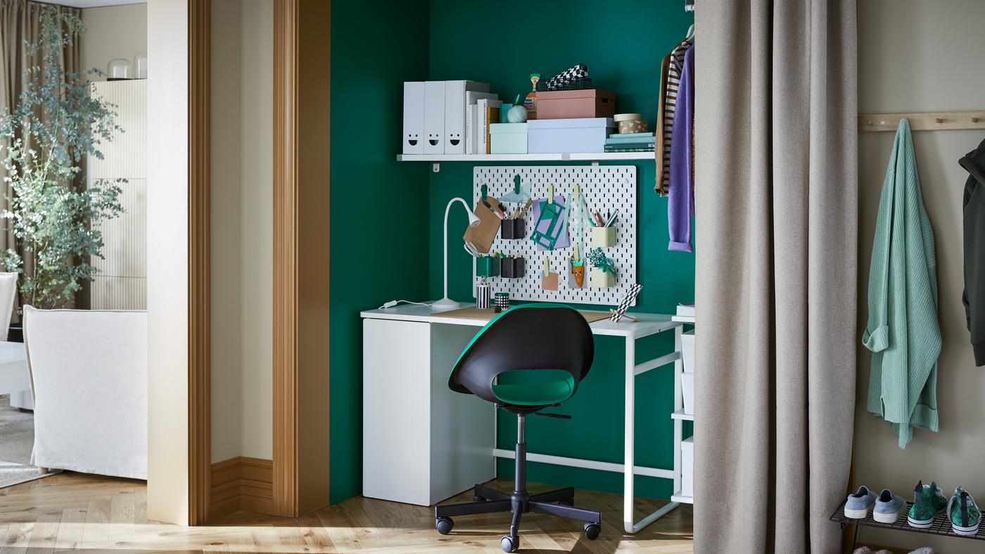 A LÄRANDE desk and ELDBERGET/MALSKÄR swivel chair sit inside a closet. A SKÅDIS pegboard with office supplies is on the wall.