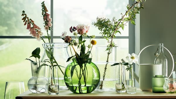 A large assortment of vases all with flowers and foliage. 
