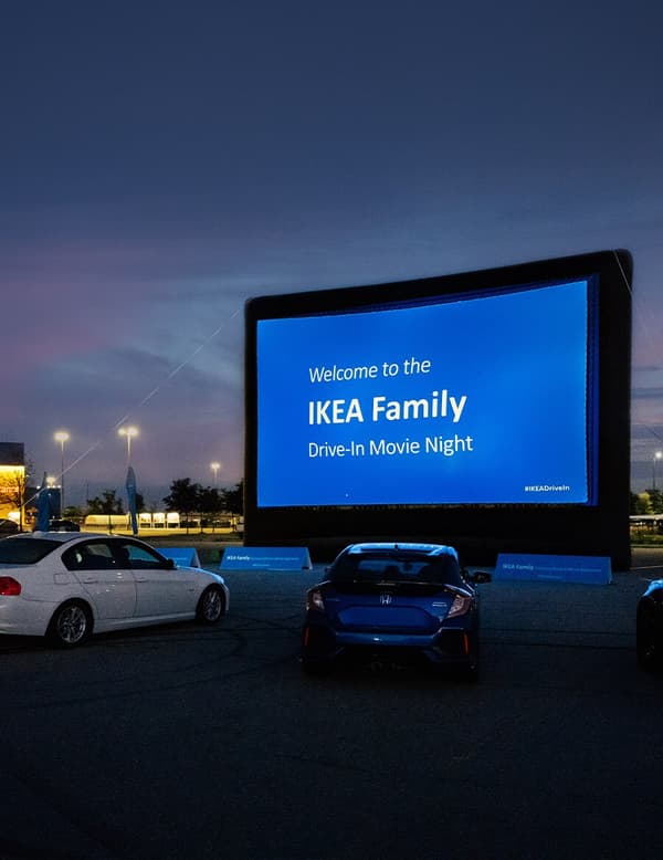 A large drive-in movie screen at sunset.