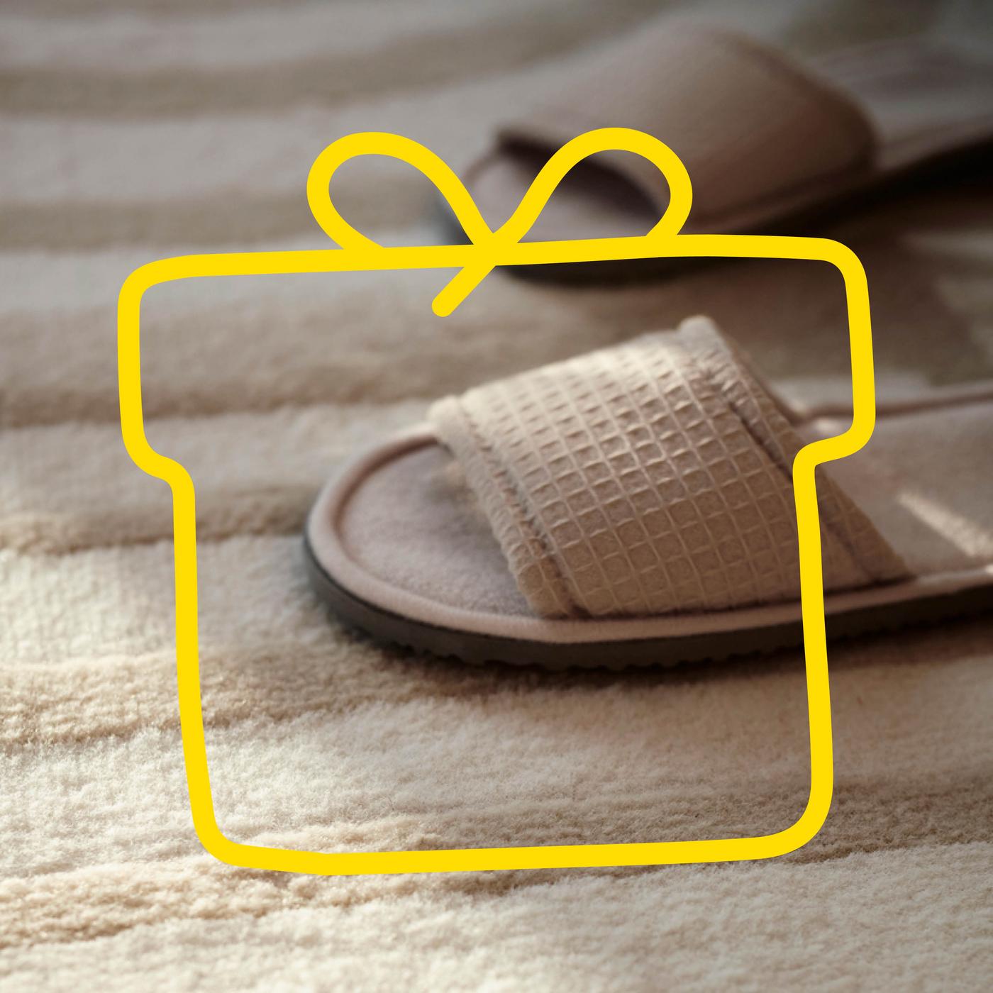A large pile of mattresses stacked on each other against a blue background.